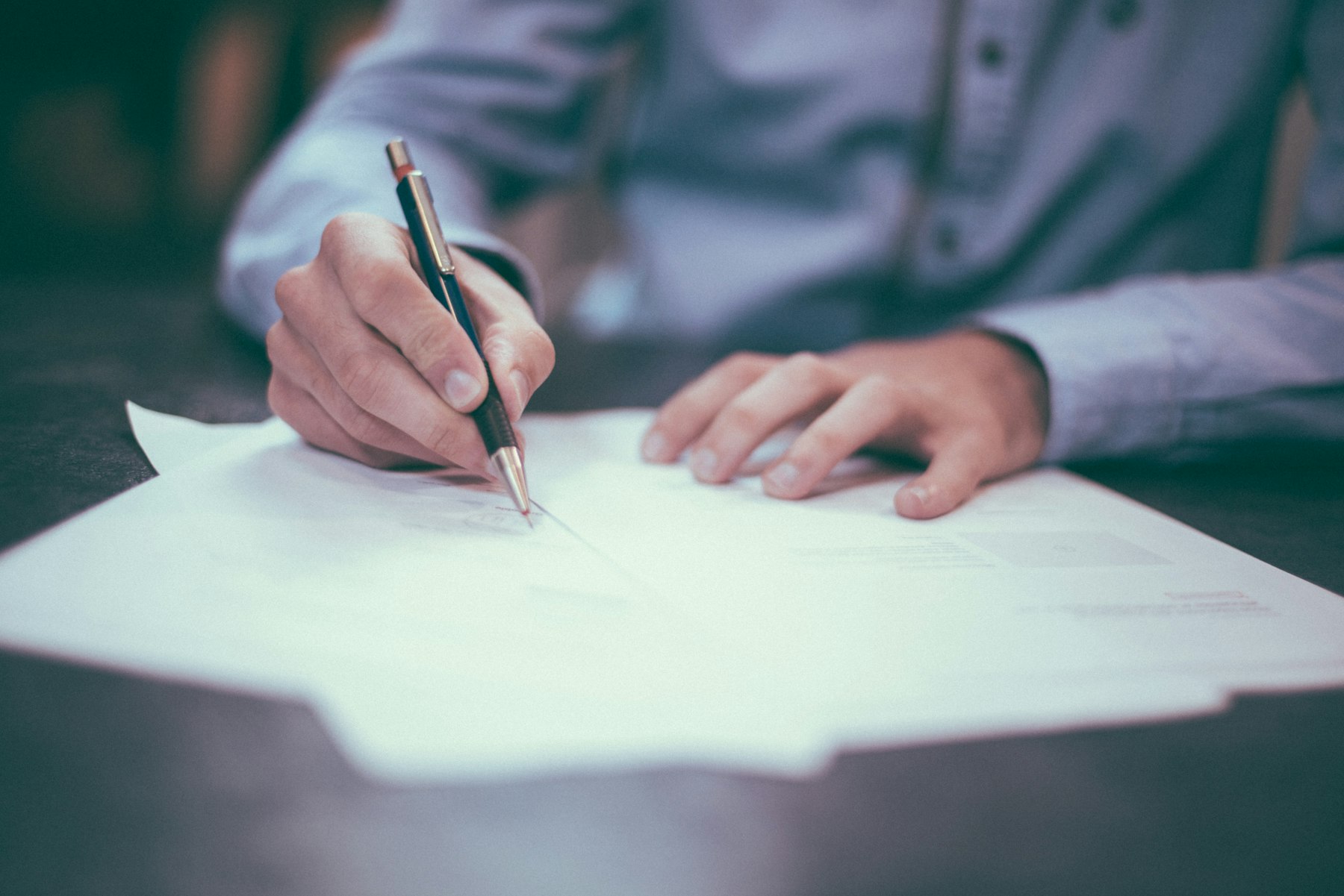 Procurement documents and contract review on an office table